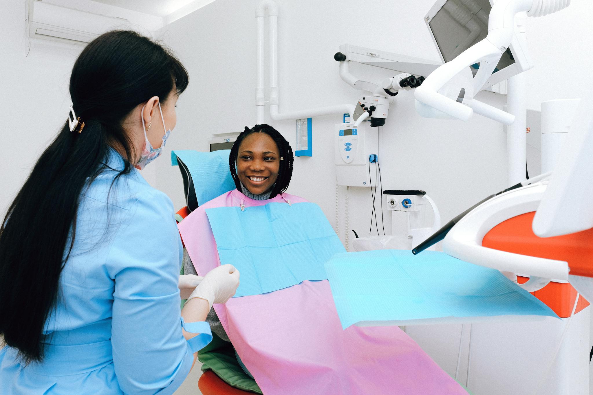 A happy patient receives a dental check-up in a modern clinic with professional care.